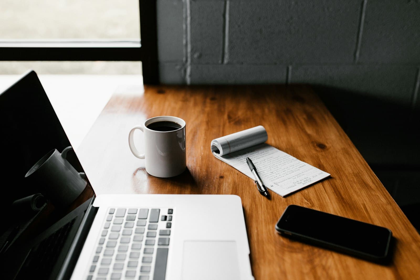 Clean workspace with laptop and notebook